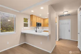 Breakfast seating at kitchen, door offer direct entry to unit from garage.