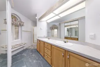 Primary bathroom, with two sinks and a convenient area to sit down to put your shoes on!