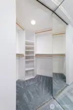 Primary bedroom closet - very roomy, with shelving.