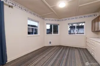 This is the hobby room behind the garage!  Great for crafts or wood-working? Private office space? Workout room?Sliding glass door on the left leads into the back yard.