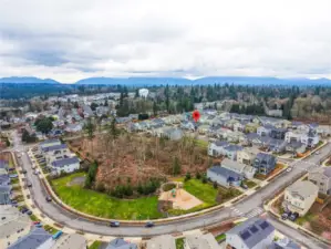 Aerial perspective of this Covington WA home for sale highlighting the surrounding neighborhood, community streets, and convenient access to shopping, parks, and commuter routes in Covington Washington.