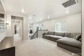 Versatile upstairs loft area perfect for a media room, office, or play space in this Covington WA home for sale.