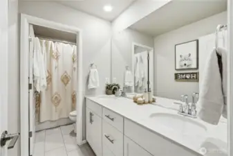 Full bathroom serving additional bedrooms with clean modern finishes in this Covington WA home for sale.d