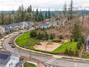 Aerial view of nearby community park, walking paths, and surrounding homes near this Covington WA home for sale, highlighting the neighborhood lifestyle and outdoor amenities.