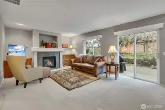 Lower level family room with gas fireplace and a slider for easy access to outdoor areas.