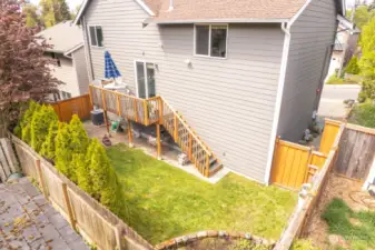 Fenced back yard with deck and patio for summer fun and enjoyment! A raised  garden space to plant your favorite veggies or flowers!