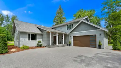 Nestled on just over an acre this beautiful home has 3500 sq ft with two primary suites, an office and large rec room.