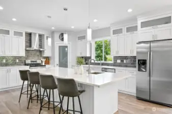 Upgraded appliances, quartz countertops, an abundance of cabinets and a walk in pantry highlight the kitchen.