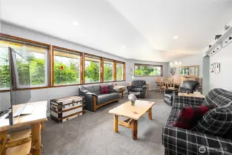 Living Room with new triple pane glazed windows blocking harmful UV Rays, and contributing energy efficiency by deflecting heat to its source. Living Room flows effortlessly into the formal Dining Room.