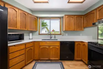 Kitchen with quartz countertop, great lighting and views of nature.