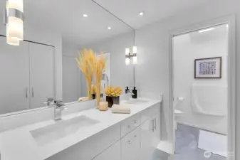Beautifully updated primary bath with quartz countertops and beautiful walk in shower.