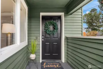 Covered front porch welcomes you with new flooring