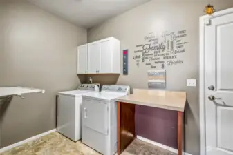 Experience effortless efficiency in the generously sized laundry room, complete with a built-in ironing rack and folding counter.