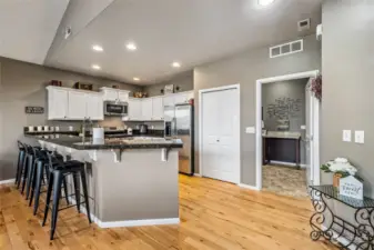 Style meets function in the beautifully appointed kitchen, completed with sleek stainless steel appliances, granite counters, and crisp white cabinetry.