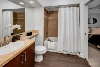 Primary bath features both en suite and guest access. Modern touches include stylish pulls and fixtures including brand new brushed nickel faucet and shower head w/sprayer!
