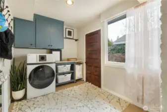 Even the laundry room is quaint with it's tile flooring & gorgeous door leading to the courtyard. The combo washer/dryer makes doing laundry a breeze