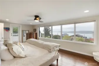 The upper level primary suite has sweeping views & engineered hardwood flooring. The side door leads to your private view deck where you can enjoy your morning coffee or evening glass of wine. Imagine waking to those gorgeous views each day