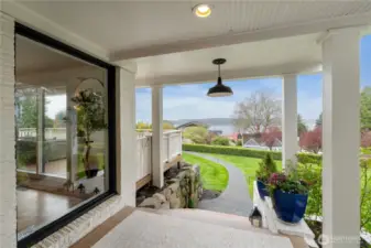 Stone steps from the front parking area and a winding sidewalk lead to the charming covered porch and there is a gate to the main level view deck