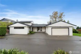 The quiet alley side of the home shows the 2 car garage and added parking off the back entrance