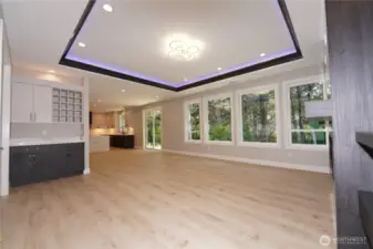 The great room has a tray ceiling with hidden LED lighting