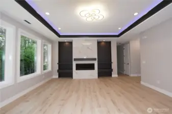 The living room has four huge windows to bring in lots of light