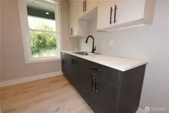 The laundry has a large counter and lots of cabinets