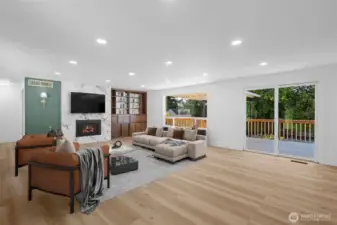 Virtually staged. Comfortable gathering space for residents, family, or guests. Sliders lead to the sizeable deck.