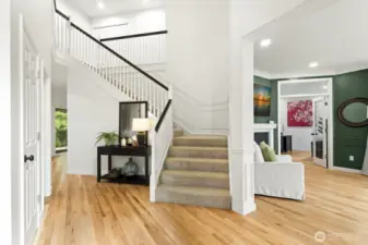 Step inside through the impressive double-door entry into a dramatic two-story foyer.