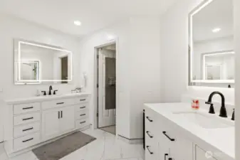 Dual quartz vanities with back lit LED mirrors.