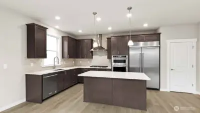 Gorgeous kitchen with plenty of storage and counter space to prep your meals or host a dinner party!  48" counter depth side by side built in refrigerator, gas cooktop and built in micro/oven. Home for sale may differ in cabinet color.