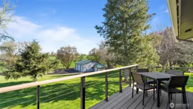 This lovely front deck, just off the kitchen, is plumbed for a grill and is such a wonderful place from which to take in sunsets and the beauty of the property.
