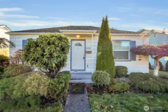 Welcoming front entry with established landscaping.
