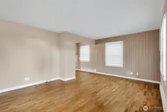 Light-filled living space with hardwood floors.