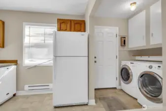 Spacious utility room with full-size washer and dryer.