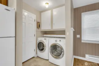 Laundry area with additional storage options.