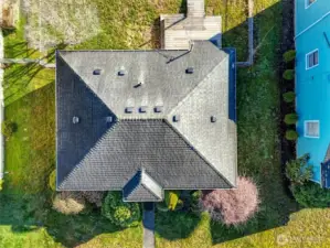 Overhead view showcasing rooflines, lot layout, and surrounding homes.