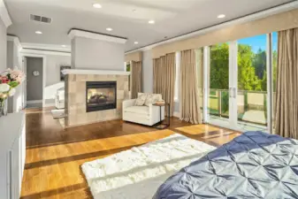 Large primary retreat with double fireplace with private deck access