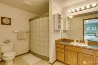 Primary bathroom with spacious vanity and tub/shower.