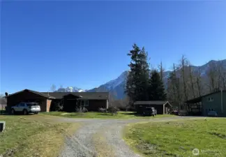 The home is set back from the road, with Whitehorse Mountain in the background.
