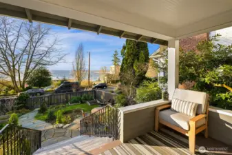 The porch offers a wonderful spot to enjoy morning coffee, evening sunsets and boat activity on the bay