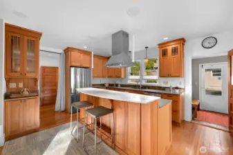 The kitchen features warm cherry cabinetry, new countertops and stainless appliances
