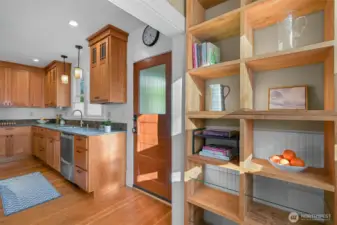 Right off the kitchen is additional open storage as well as a nicely sized back entry perfect for dropping coats, muddy boots, etc