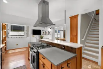 The staircase leading upstairs has custom carpet treads; the main floor bedroom and bathroom are located to the right of it