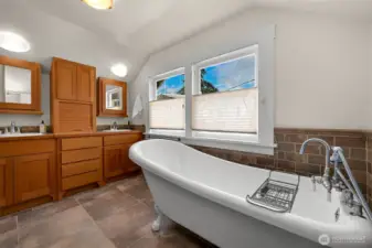 The primary bathroom also features cherry cabinetry and a relaxing, extra long clawfoot soaking tub!