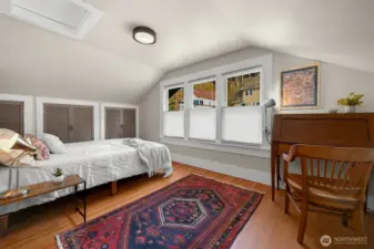 The second upstairs bedroom has abundant storage behind the louvered doors and gets wonderful morning light