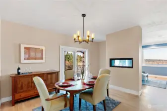 Formal dining room with gas fireplace to set the room aglow.