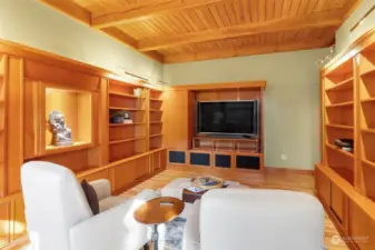 An impressive main level library meets home theater room, or use as a private home office.