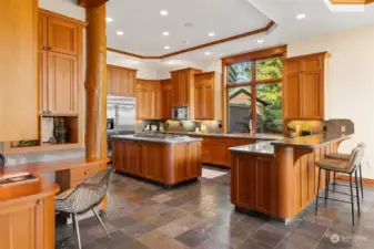 A kitchen as grand as the home it serves. Abundant Douglas Fir cabinets, granite counters, slate flooring with radiant heat throughout. Passionate cooks and those who just love to eat the end product will enjoy this space with equal measure.