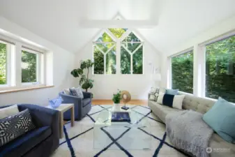 Vaulted and beamed ceilings with feature window.