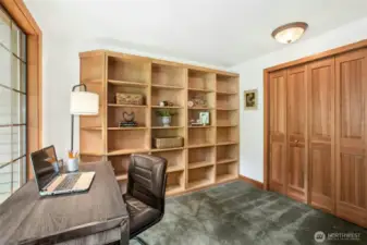Great den/office/library with a closet and more built in bookshelves on the right side of the room.